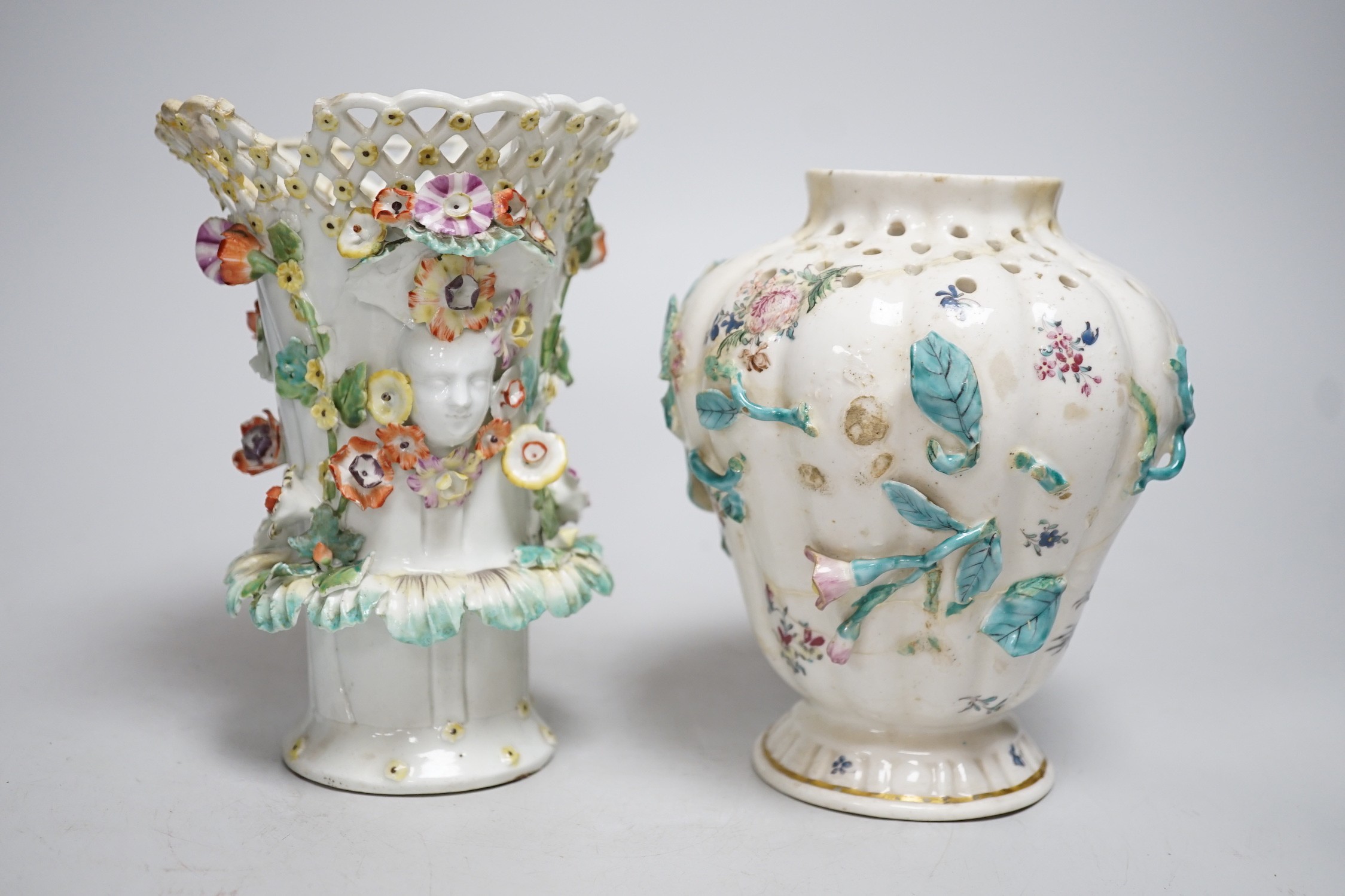 An 18th century Chelsea pot pourri vase, red anchor period, encrusted and painted with leaves and flowers and a Bow frill vase with mask heads encrusted with flowers. Tallest 16.5cm